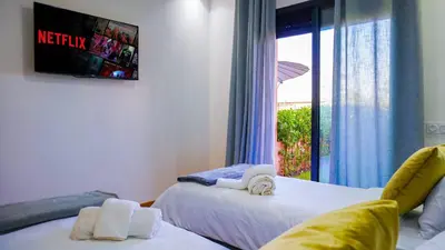 a bedroom with two beds and a window with a view at Havre de Paix à Noria Golf Marrakech in Marrakech