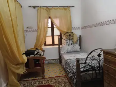 a bedroom with a bed and a window at Appart 3 mins from Jamaâ el fana in Marrakech