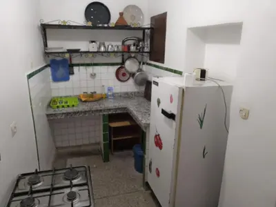 a small kitchen with a refrigerator and a stove at Appart 3 mins from Jamaâ el fana in Marrakech
