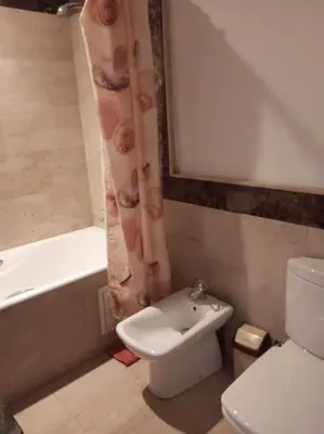 a bathroom with a toilet and a sink and a bath tub at Le Fairouz Appartement Haut Standing centre ville Piscine in Marrakech