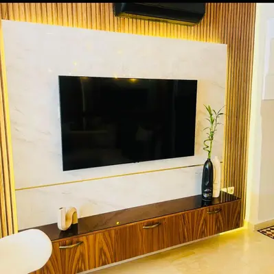a large flat screen tv on a wall at Logement de luxe avec piscine, hivernage in Marrakech