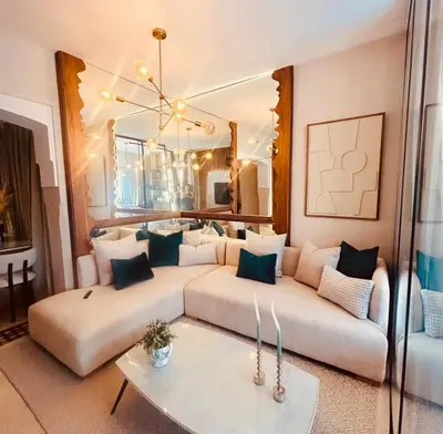 a living room with two couches and a large mirror at Logement de luxe avec piscine, hivernage in Marrakech