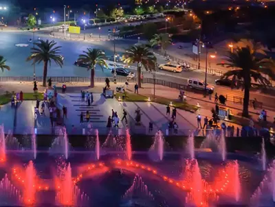 a fountain in a park at night with a beach at Logement de luxe avec piscine, hivernage in Marrakech