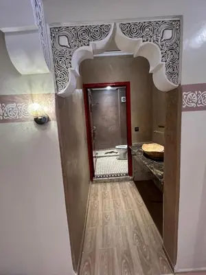 a hallway with a bathroom with a shower and a mirror at Charmant appartement spacieux avec cour fleurie et Hammam à Targa Marrakech in Marrakech