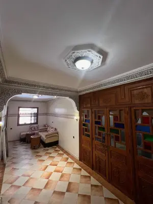a living room with a couch and a ceiling at Charmant appartement spacieux avec cour fleurie et Hammam à Targa Marrakech in Marrakech