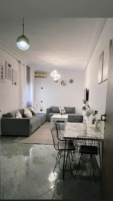 a living room with a couch and a table at Gueliz Marrakech Apartment 5 Min City Center in Marrakech