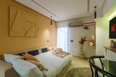 a bedroom with a bed in a room at New ! Appartement DarSun - Terrasse - Fibre - Parking by Darlease in Marrakech