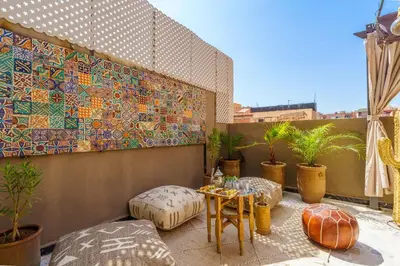 a balcony with a table and a mosaic wall at New ! Appartement DarSun - Terrasse - Fibre - Parking by Darlease in Marrakech