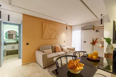 a living room with a couch and a table at New ! Appartement DarSun - Terrasse - Fibre - Parking by Darlease in Marrakech