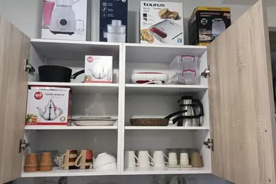 a cupboard filled with lots of kitchen items at Modern family apartment near airport in Marrakech