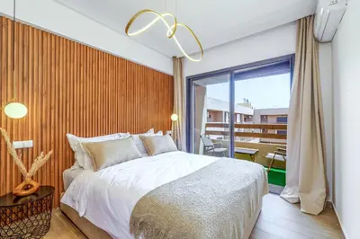 a bedroom with a large bed and a balcony at Elegant and cozy 3 bedrooms in Hivernage in Marrakech