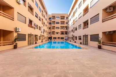 an empty swimming pool in an apartment building at Elegant and cozy 3 bedrooms in Hivernage in Marrakech