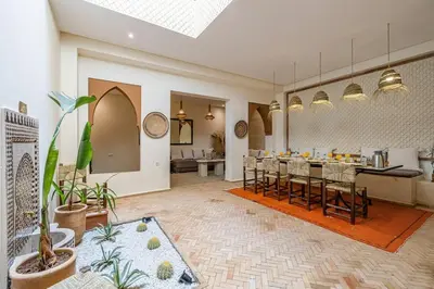 a dining room with a long table and chairs at Riad Macan Exclusive and Trendy Chich Breakfast incl in Marrakech