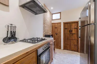 a kitchen with a stove and a refrigerator at Riad Zatiah Exclusive and chic breakfast incl in Marrakech
