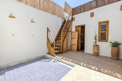 a room with a staircase and a stair case at Riad Zatiah Exclusive and chic breakfast incl in Marrakech