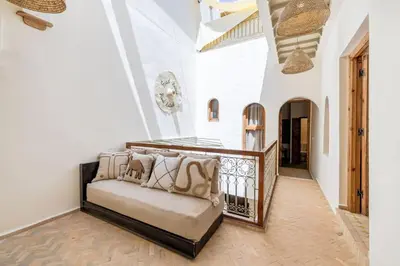 a living room with a couch and a balcony at Riad Zatiah Exclusive and chic breakfast incl in Marrakech