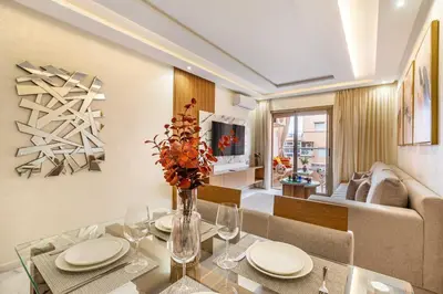 a dining room and living room with a glass table at Magnifique appartement unique et central! in Marrakech