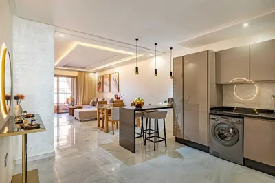 a kitchen and living room with a washer and dryer at Magnifique appartement unique et central! in Marrakech