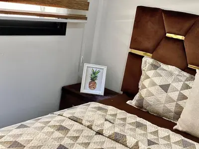 a bedroom with a bed and a picture of a pineapple at Appartement de luxe en face la gare à gueliz marrakech in Marrakech