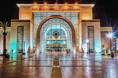 a large building with a large entrance at night at Appartement de luxe en face la gare à gueliz marrakech in Marrakech