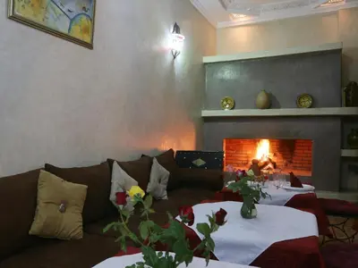a living room with a couch and a fire place at Riad El Bellar in Marrakech