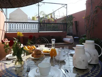 a table with food and drinks on a patio at Riad El Bellar in Marrakech