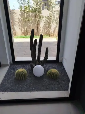 a cactus statue sitting in front of a door at Villa Moderne au sein du Golf Amelkis in Marrakech