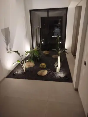 a hallway with plants and rocks on the floor at Villa Moderne au sein du Golf Amelkis in Marrakech