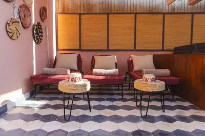 a waiting area with two chairs and two tables at Riad JW Yacout, vivez l'expérience Medina in Marrakech