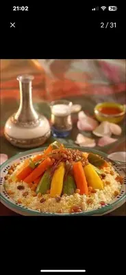 a plate of food with vegetables on a table at Appartement luxe Prestige Opale Golf in Marrakech