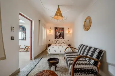 a living room with a bed and a couch at Riad privatisé terrasses et matin gourmand in Marrakech
