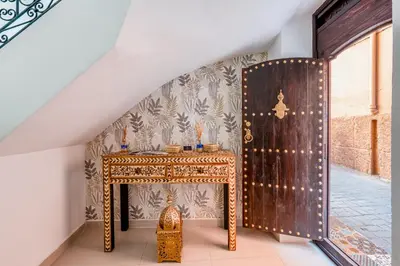 a room with a gate and a table with candles at Riad privatisé terrasses et matin gourmand in Marrakech