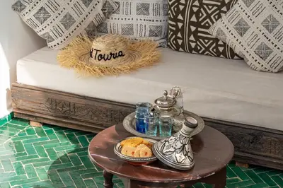 a tray of food on a table next to a bed at Riad privatisé terrasses et matin gourmand in Marrakech