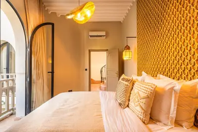 a bedroom with a large bed with white pillows at Suites & Spa - Riad XO in Marrakech