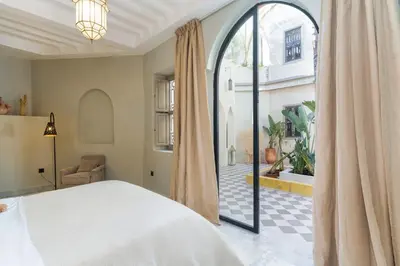 a bedroom with a bed and a large window at Suites & Spa - Riad XO in Marrakech