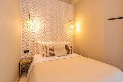 a small bedroom with a bed with two pillows at Suites & Spa - Riad XO in Marrakech
