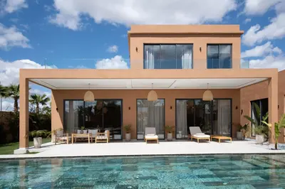 a villa with a swimming pool in front of it at Domaine de Kali, villa 2 au calme, piscine privée in Marrakech