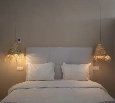 a bedroom with a white bed with two white pillows at Domaine de Kali, villa 2 au calme, piscine privée in Marrakech
