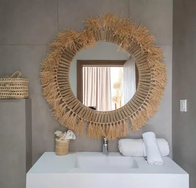 a bathroom with a round mirror and a sink at Domaine de Kali, villa 2 au calme, piscine privée in Marrakech