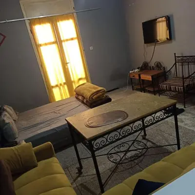 a living room with a bed and a table at Cosy & Calm studio in Marrakech