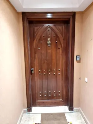 a wooden door in the corner of a room at Rêve de MARRAKECH in Marrakech