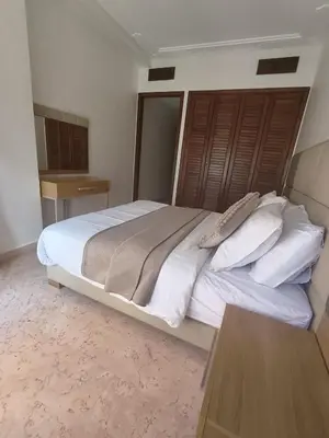 a bedroom with a large bed with white sheets and pillows at Rêve de MARRAKECH in Marrakech