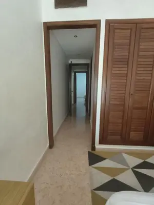a hallway with wooden doors and a room with a floor at Rêve de MARRAKECH in Marrakech