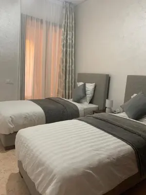 a bedroom with two beds and a window at Rêve de MARRAKECH in Marrakech