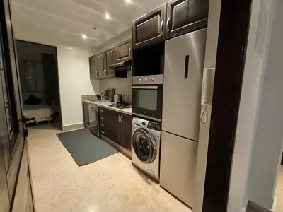 a kitchen with a stove and a washer and dryer at Rêve de MARRAKECH in Marrakech