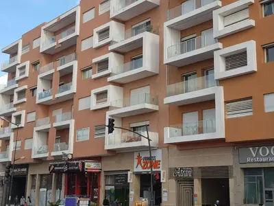 a tall building with balconies on the side of it at Cosy appartement au Centre de Marrakech in Marrakech