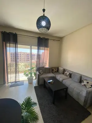 a living room with a couch and a table at Cosy appartement au Centre de Marrakech in Marrakech