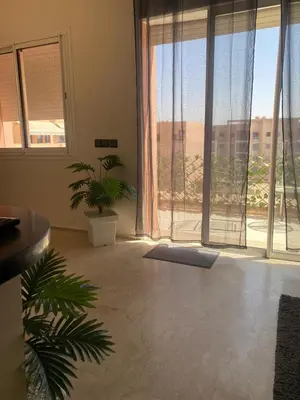 a living room with a large window and plants at Cosy appartement au Centre de Marrakech in Marrakech