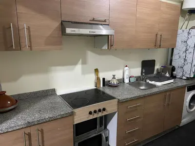 a kitchen with a stove top oven next to a sink at Cosy & Calm appartement in Marrakech