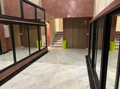 an empty room with glass doors and a room with wine racks at Cosy & Calm appartement in Marrakech